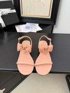 FLAT SANDALS IN PEACHY PINK CALFSKIN WITH BOW
