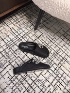 FLAT MULES IN BLACK CALFSKIN